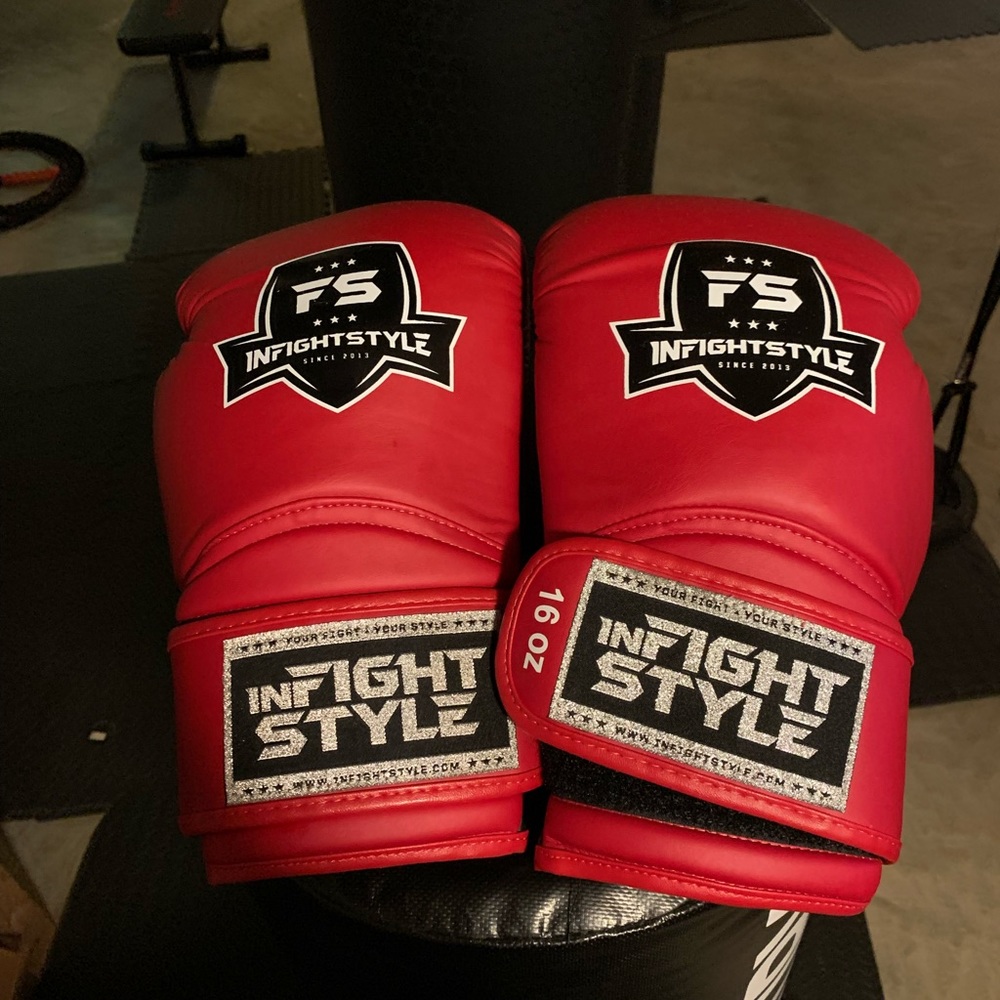 Red 16oz infight style Muay Thai gloves.